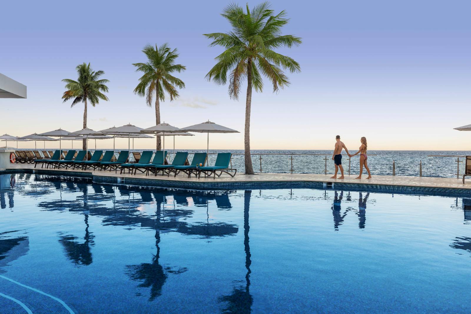 The pool deck at dusk: the rail at the far side is where the water starts