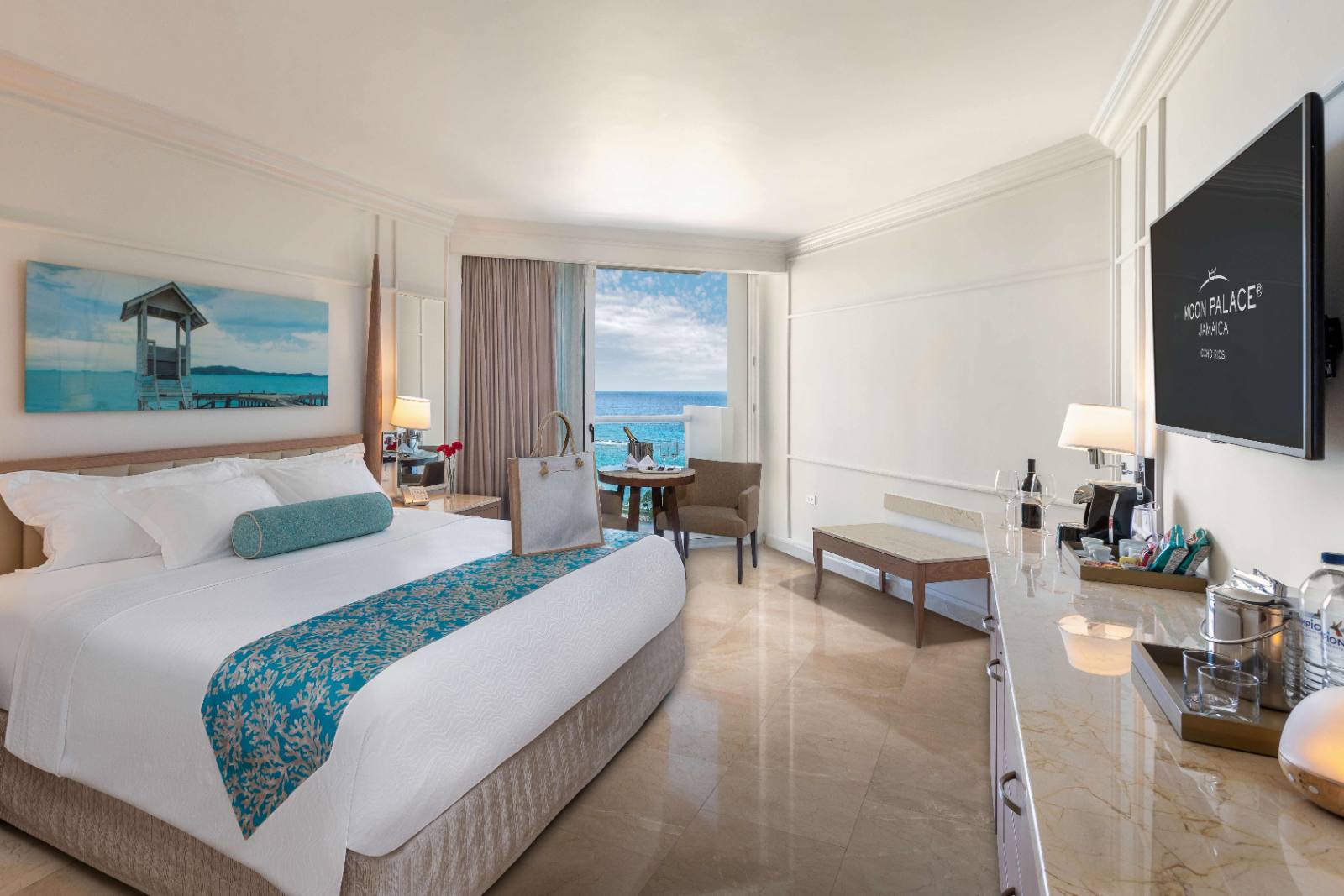 Honeymoon Suite: king bed, balcony table, open Caribbean straight ahead