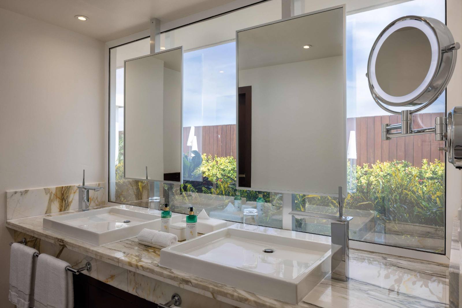 One of three baths: double vanity and a walk-in shower