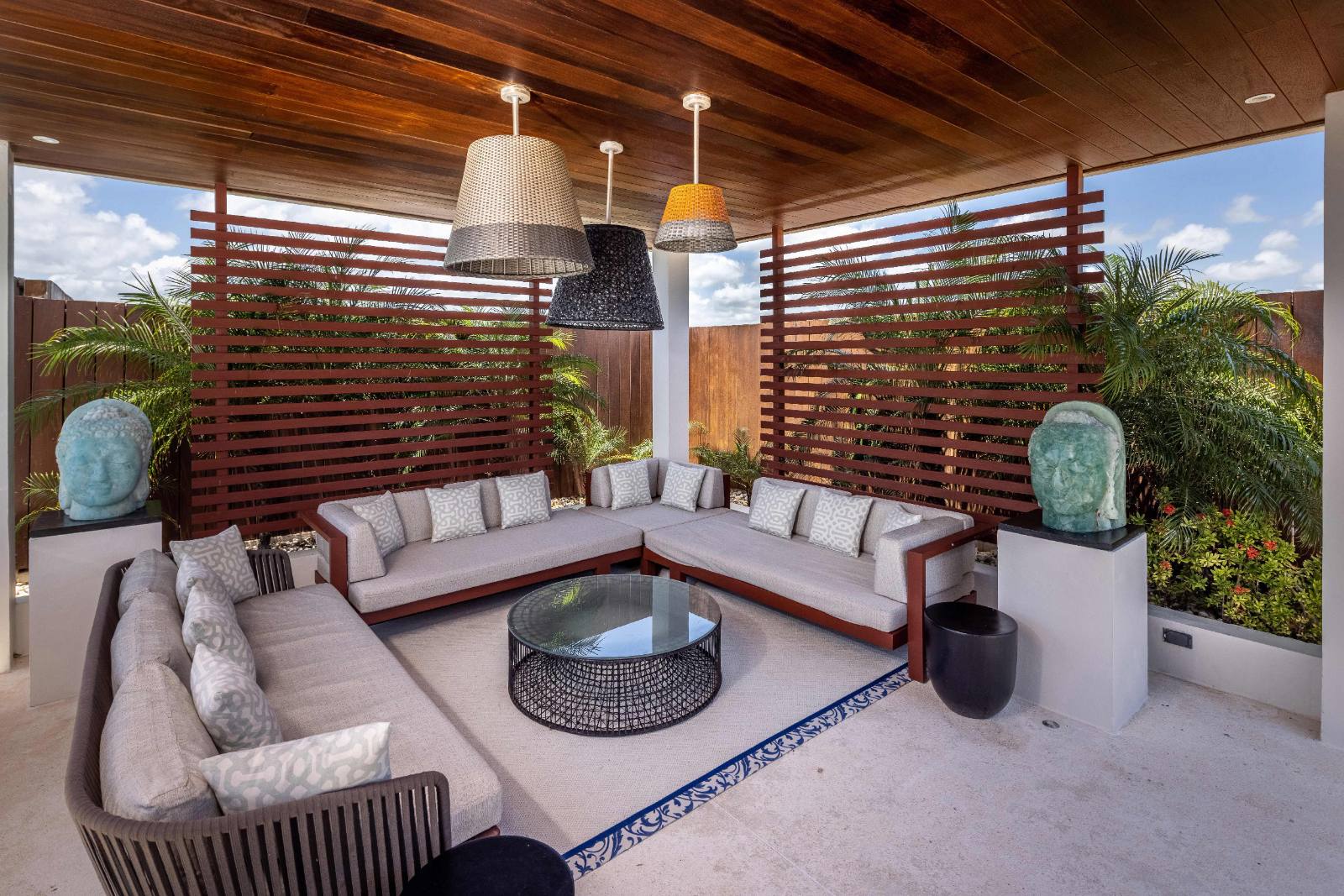The terrace at the quiet end of the property: dining table, loungers, palms