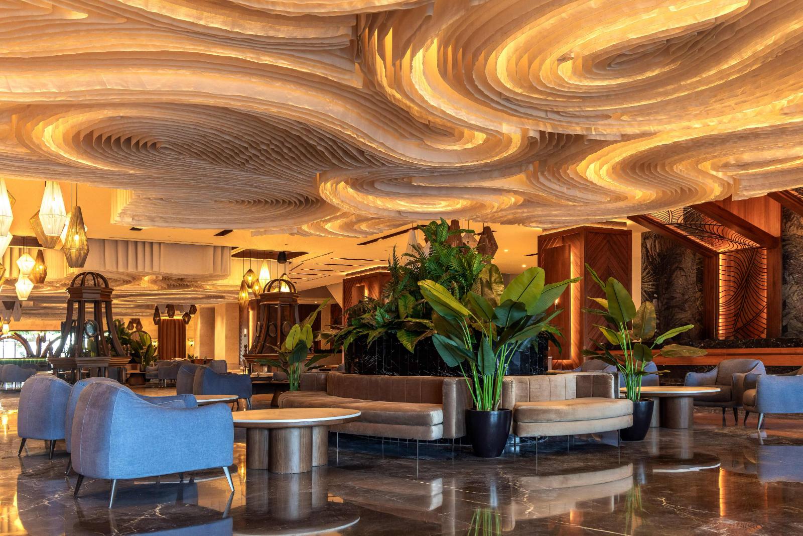 The lobby: a carved wave ceiling, planting in the middle, and no queue in sight