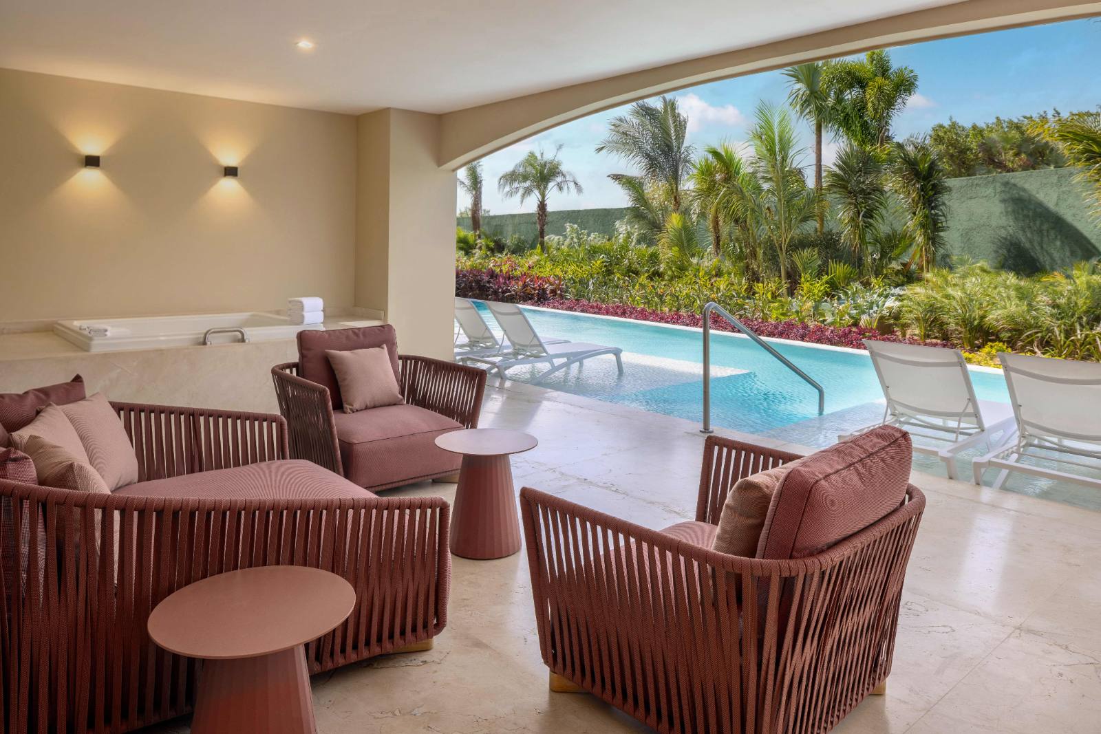 The master terrace: loungers, shade, and the sunset side straight ahead