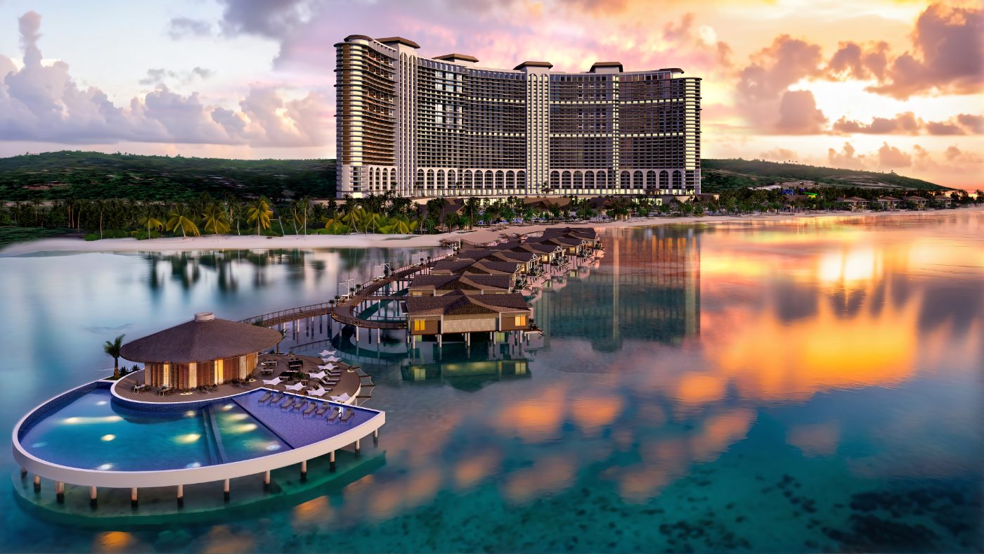Overwater suites on a boardwalk out from the beach, with a bar and pool deck at the far end