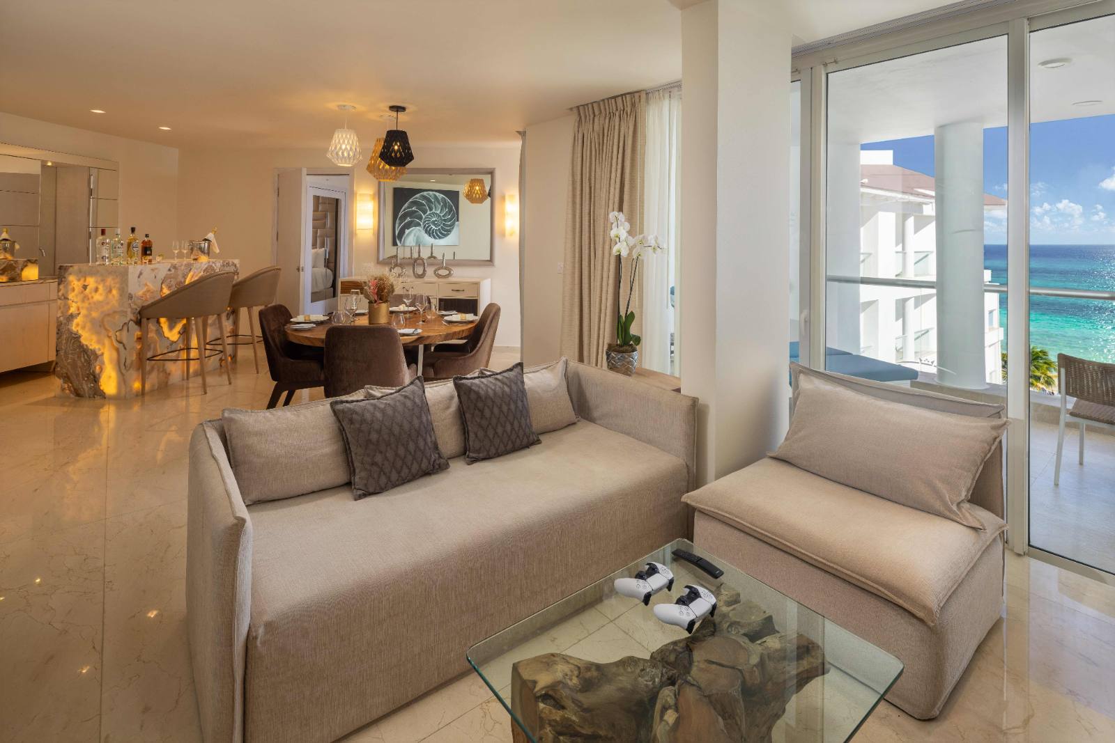 Presidential Suite: living room, dining table, onyx bar, ocean off the balcony