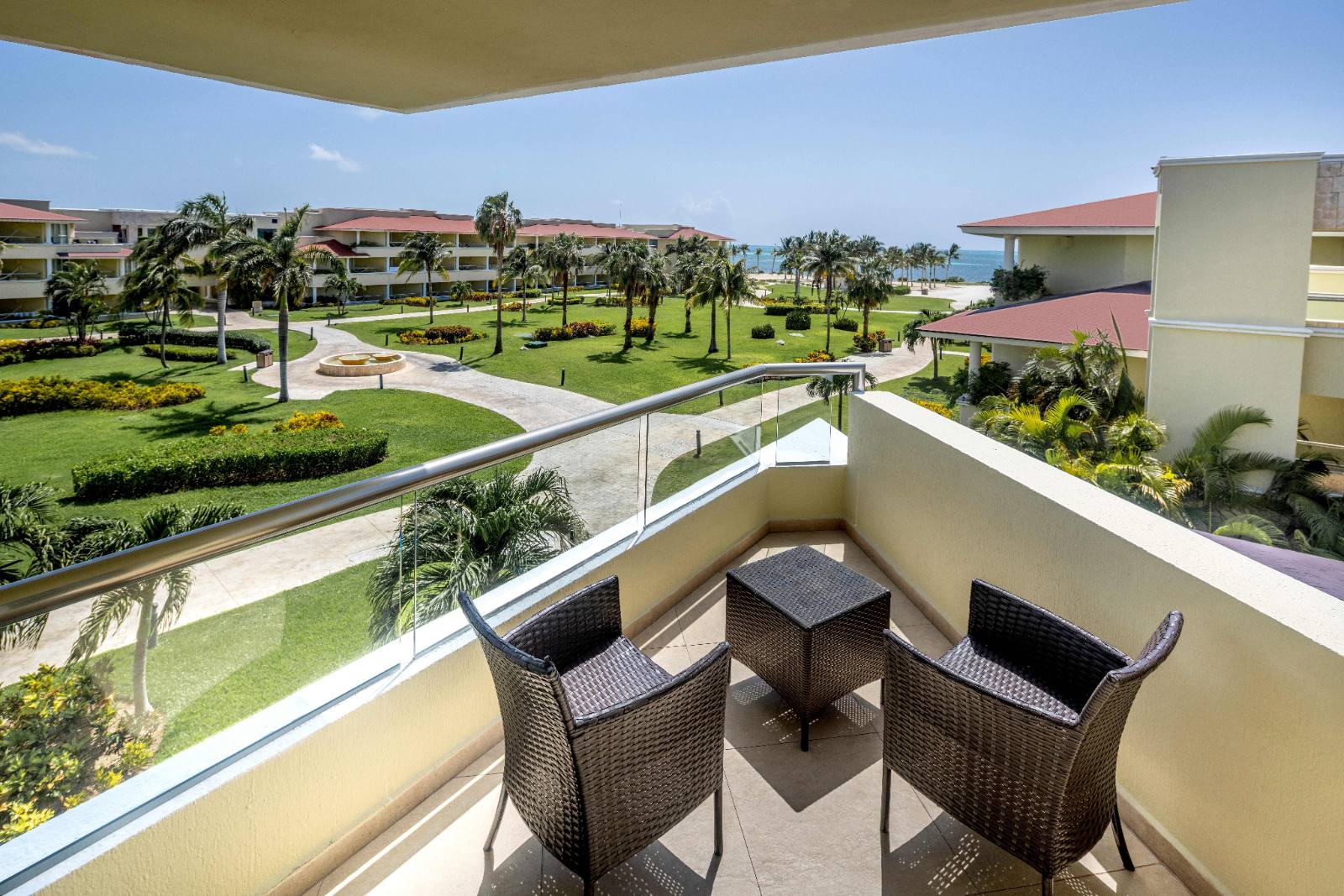Balcony of a Deluxe Resort View room, gardens and the beach beyond